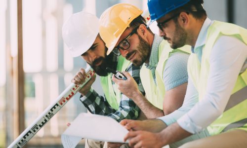 Portrait of construction engineers working on building site together